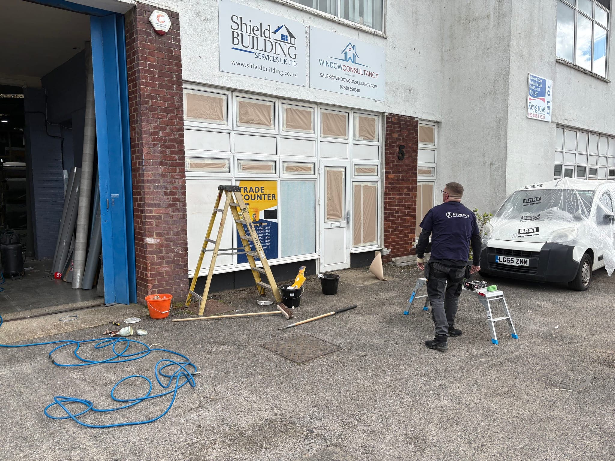Newlook operator preparing a commercial trade counter unit for respraying