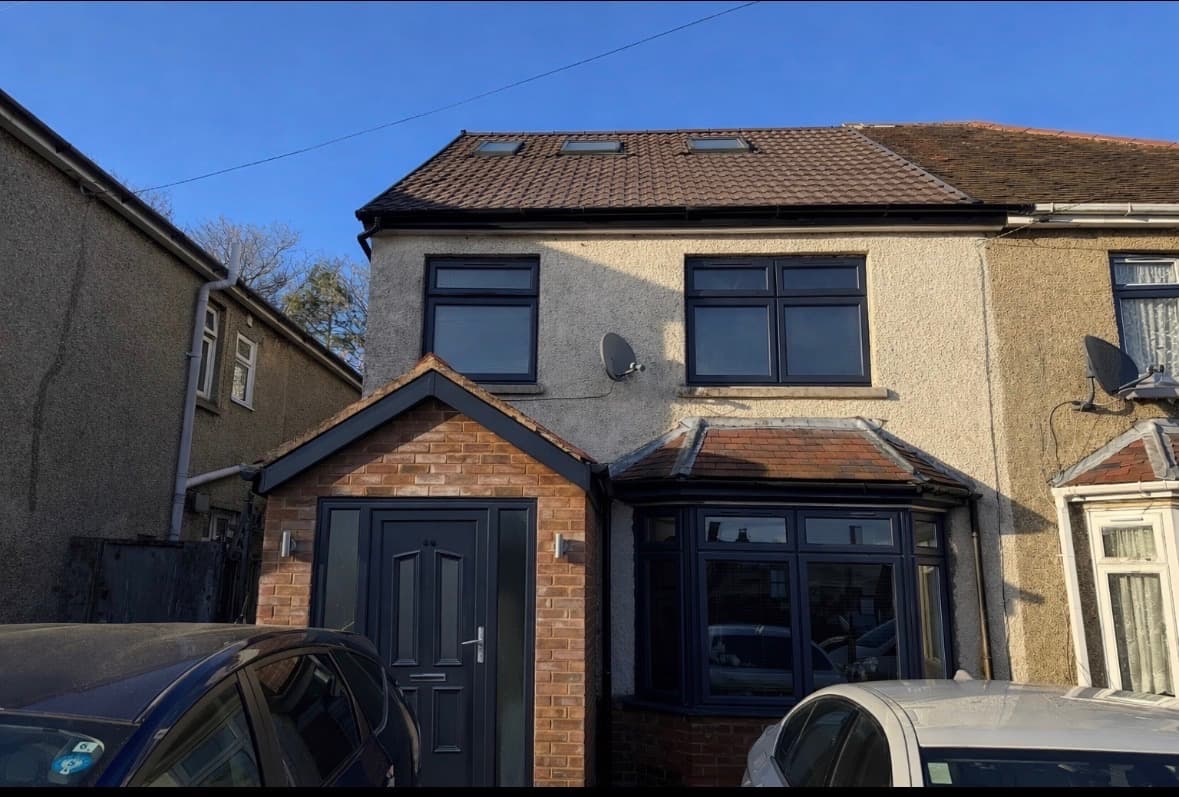 Anthracite grey UPVC porch, front door, and bay window after spraying