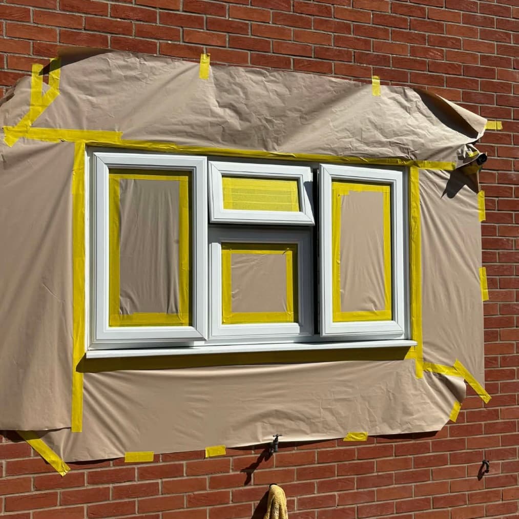 Close-up of a UPVC window precisely masked before spray application