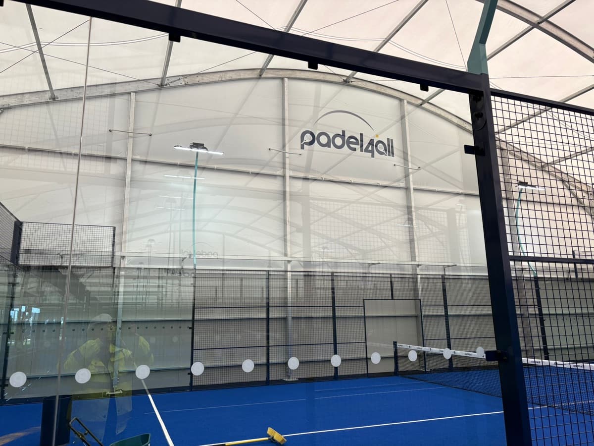 Sprayed steel framework and cladding inside an indoor padel court sports facility