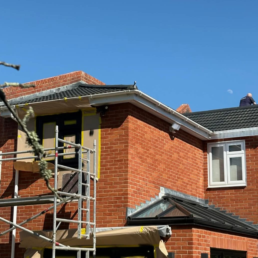 Residential property with scaffolding and masked fascia ready for spraying