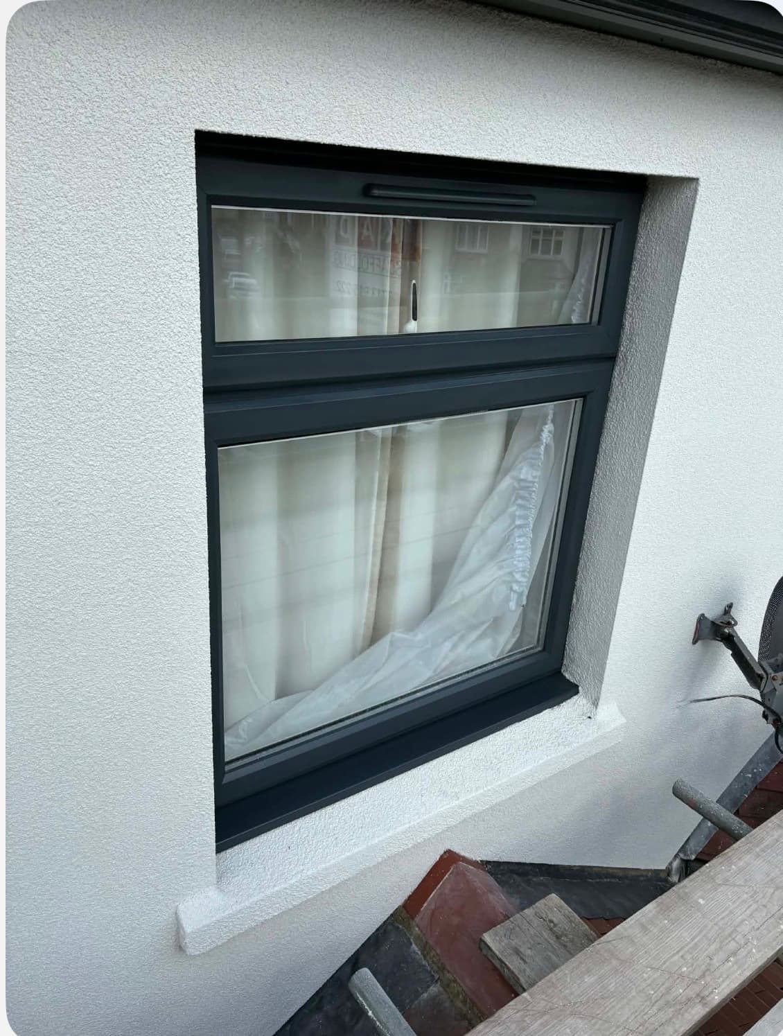 Close-up of a freshly sprayed anthracite grey UPVC window